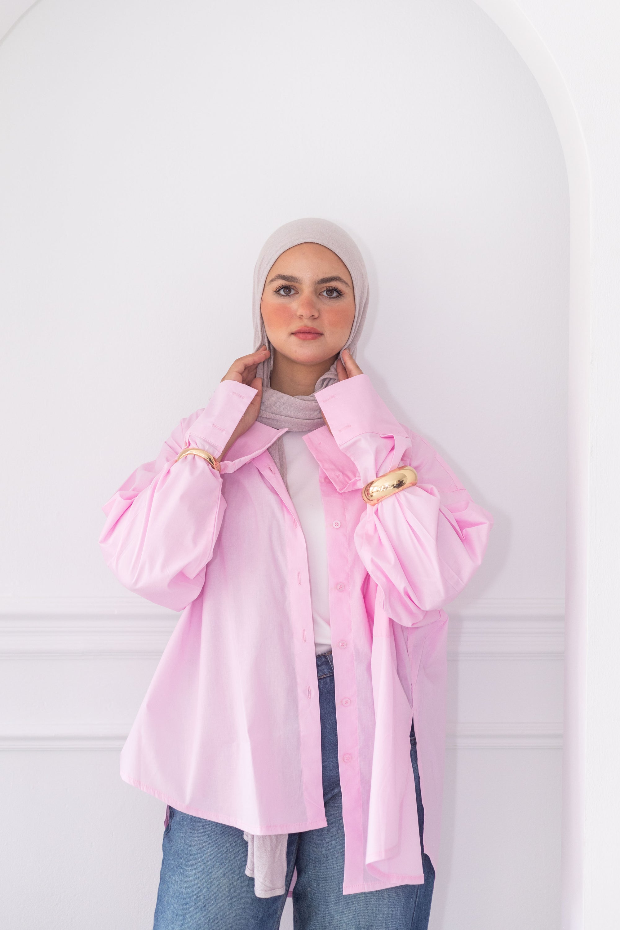 Person wearing a pink jacket with a white background