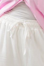 White pants with a pink garment partially covering them
