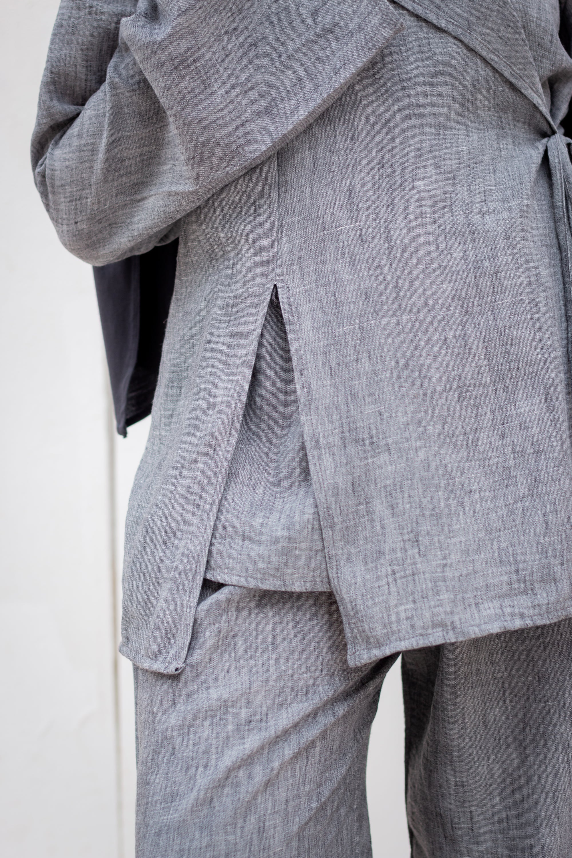 Gray suit jacket and pants on a white background